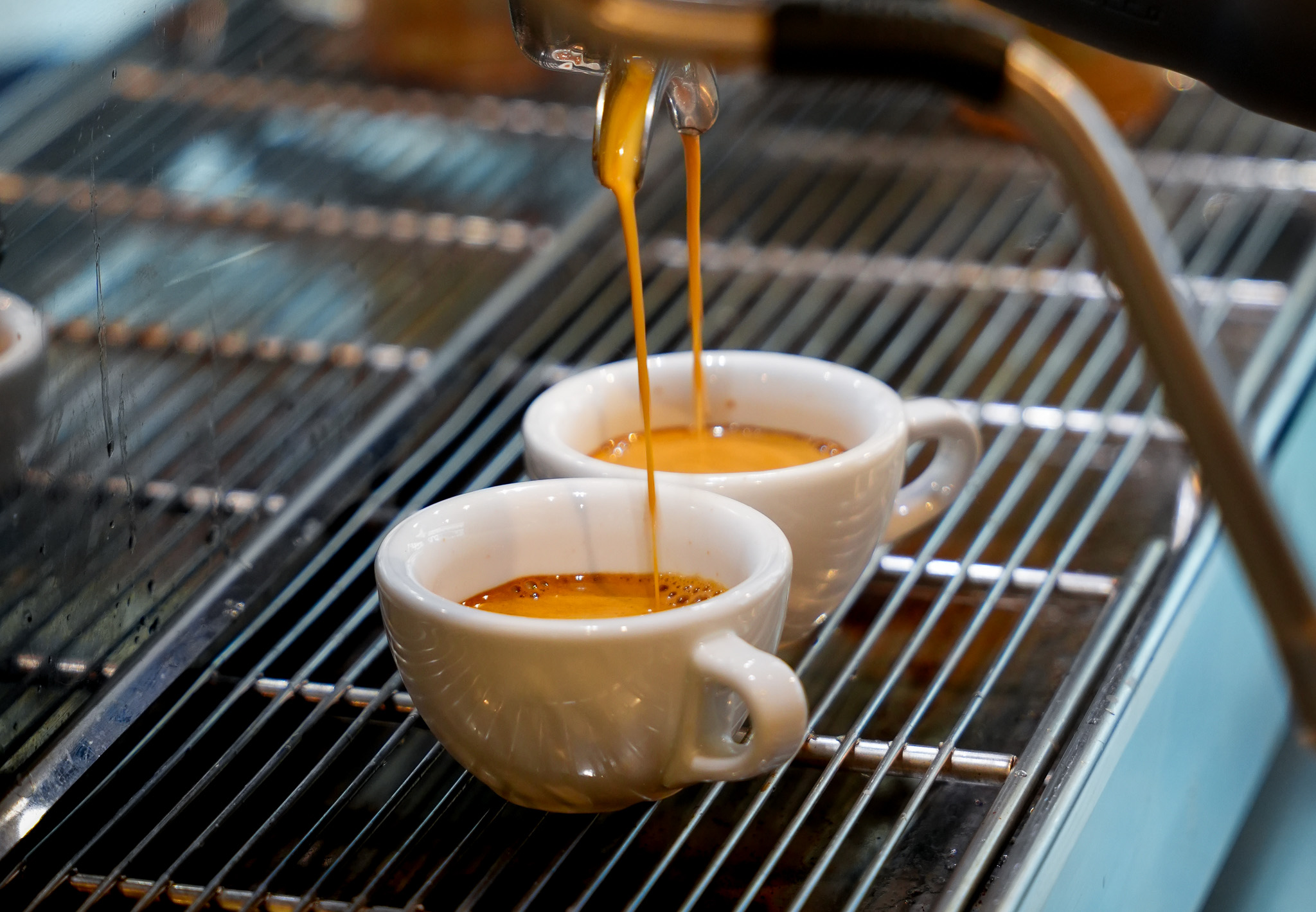 Barista pouring latte art at Cafe Fellini
