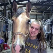 Portrait of Melissa, manager of Cattails Lodge, with a horse.
