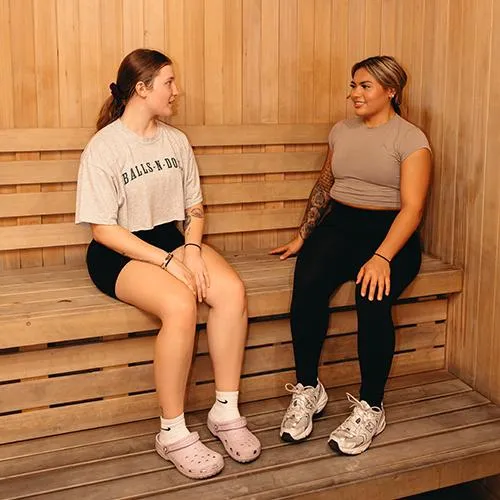 Two women enjoying a sauna session.