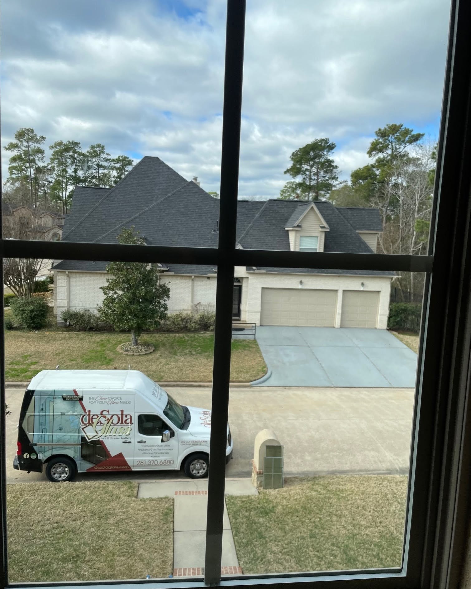 DeSola Glass, Art, & Frame Gallery pickup and delivery vehicle arriving at a residential home to transport custom framed artwork, mirrors, and picture framing projects safely and conveniently.