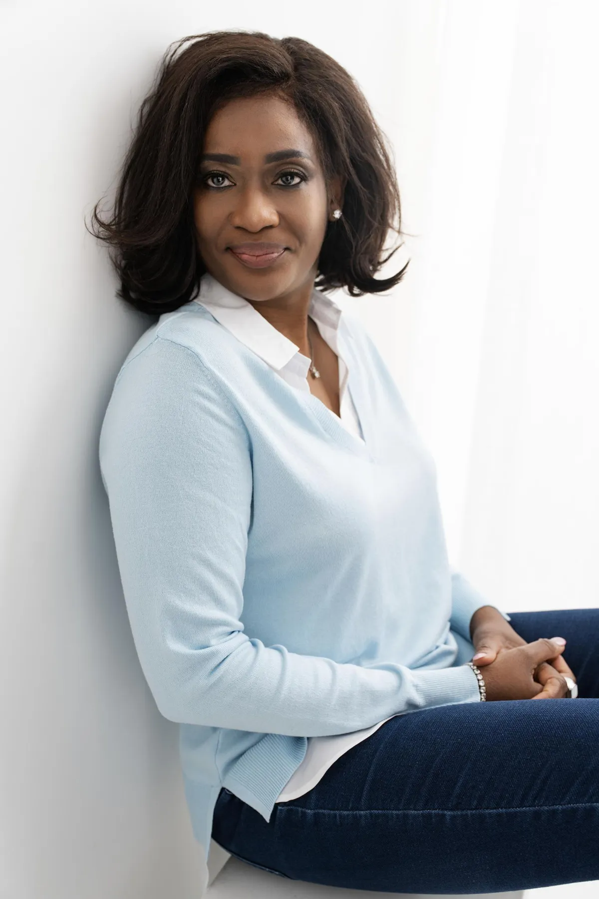 Branding photoshoot for a business owner, styled for a modern, professional look with an authentic smile.