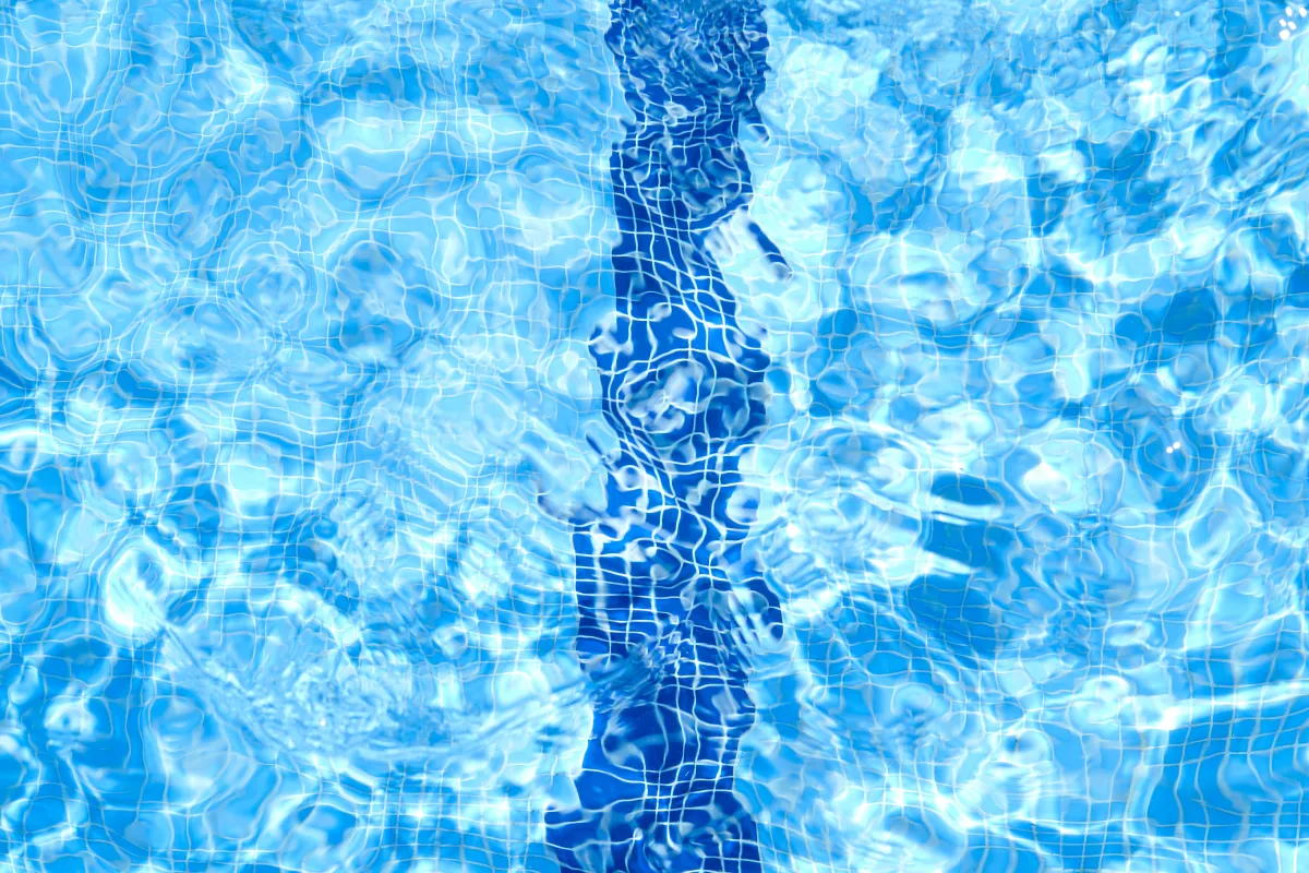 a blue swimming pool with ripples of water