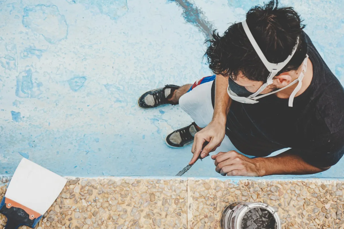 a person using a vacuum to clean a carpet