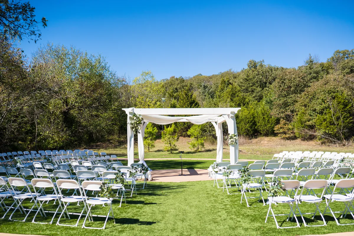 Outdoor wedding ceremony setup on the lawn at The Silo Event Center in Tulsa, Oklahoma, the September vs October wedding weather decision