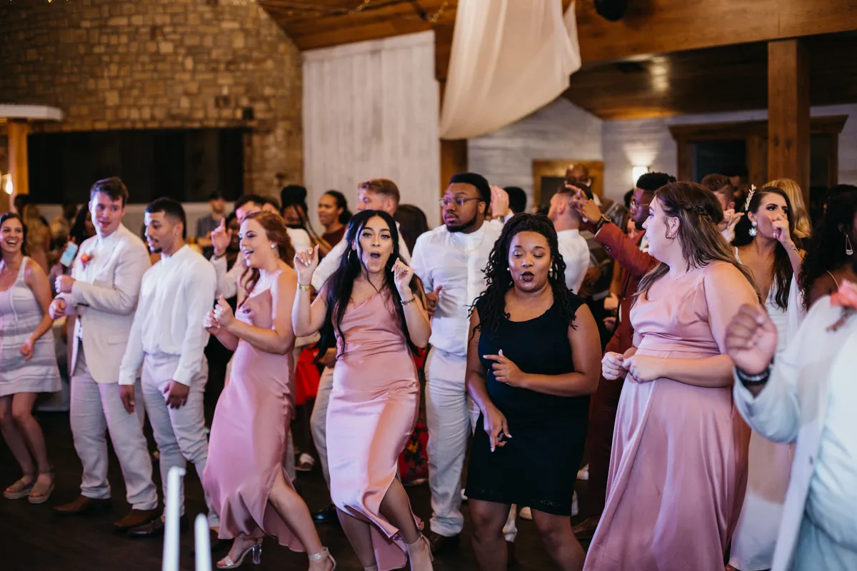 Wedding guests filling the dance floor at The Silo Event Center in Tulsa, Oklahoma, showing the wedding guest experience Tulsa couples prioritize