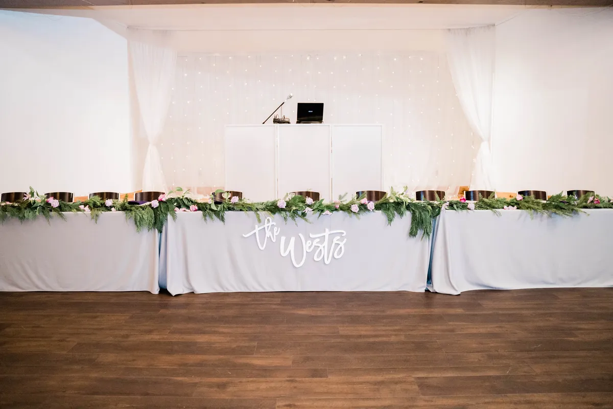 Wedding reception head table set for dinner service at The Silo Event Center in Tulsa, Oklahoma, illustrating wedding catering cost in Tulsa