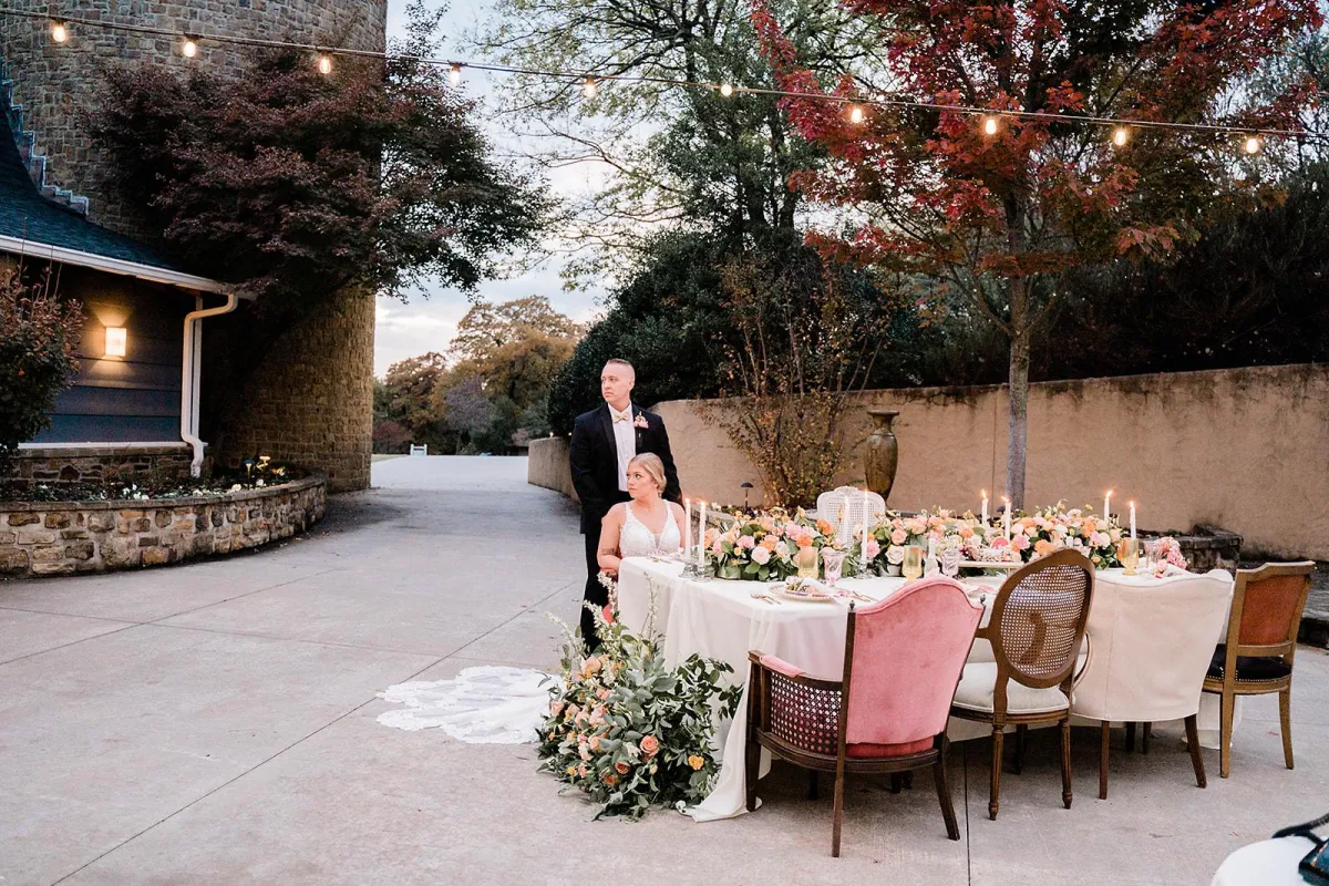 Couple cutting cake at The Silo with family around, warm lighting