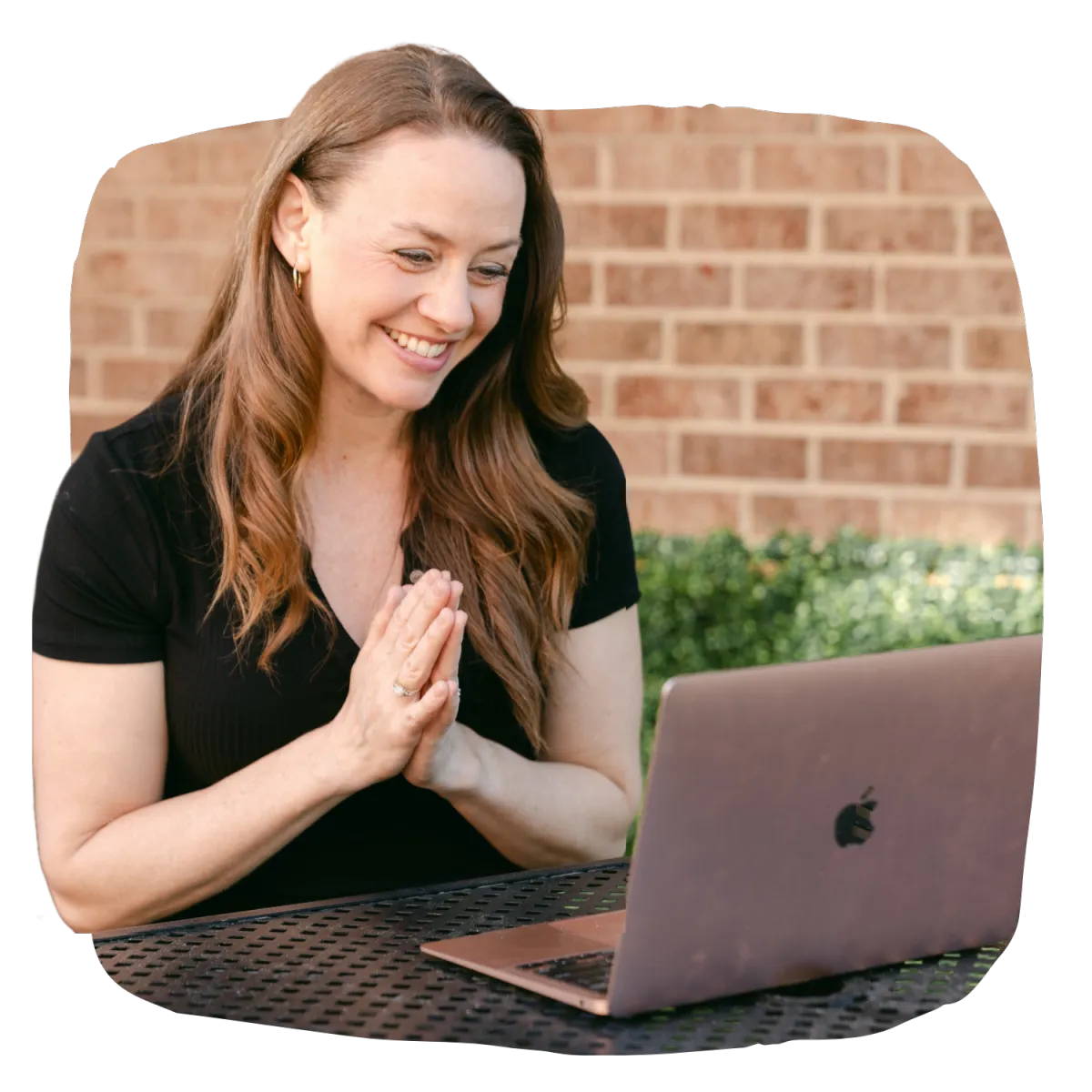 Stacy smiling while facing her laptop on a coaching call