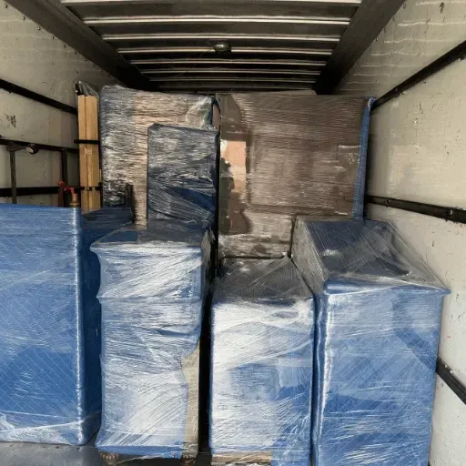 Residential movers loading household furniture into a moving truck in Manchester CT