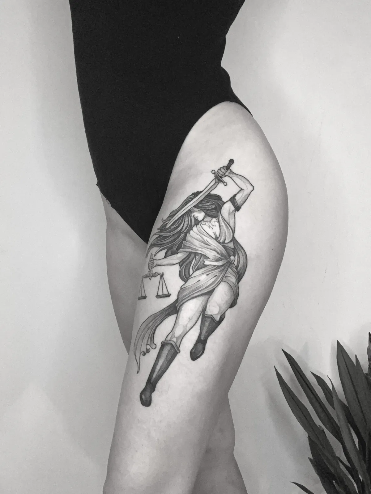 person in blue denim shorts and white nike sneakers standing on gray concrete floor