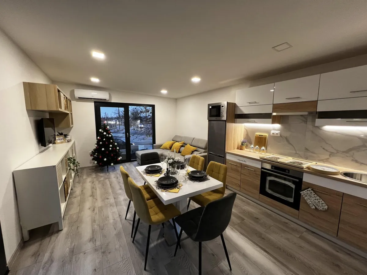 a row of buildings covered in vines on a cobblestone street
