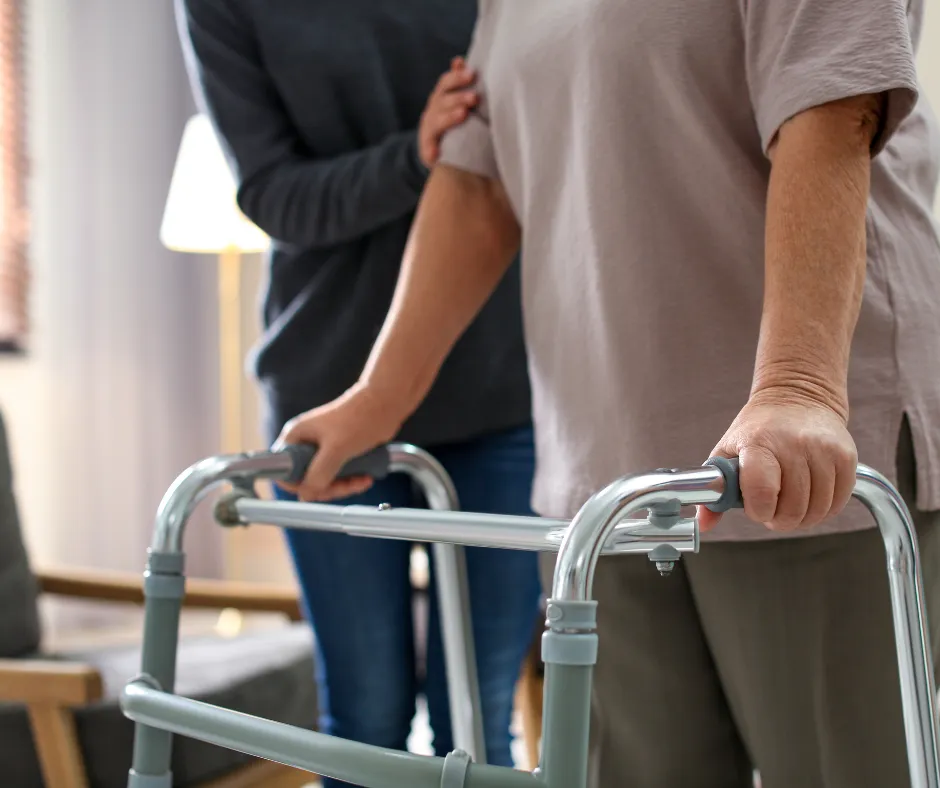 Woman using a walker assisted by her daughter