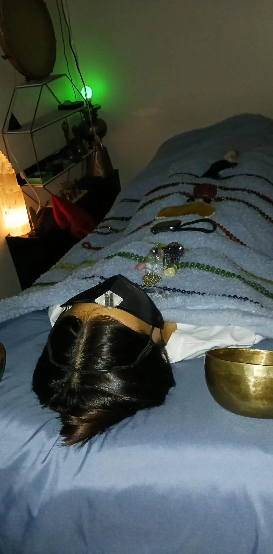 Individual in a serene setting receiving reiki and access bar and crystal healing