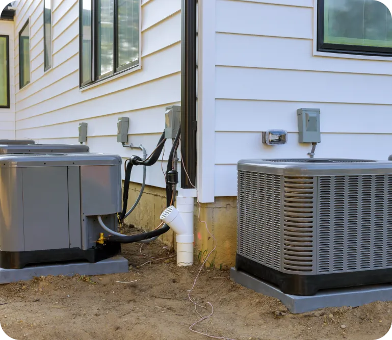 Air conditioning units installed outside a residential building, showcasing HVAC system components for cooling services in Levine, Arizona.