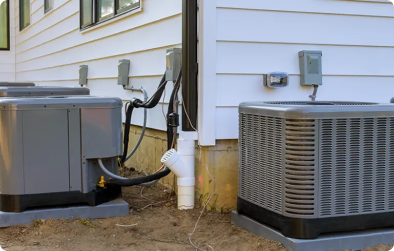 HVAC cooling systems installed outside a residential building, featuring multiple air conditioning units connected to the home, showcasing energy-efficient technology for optimal indoor climate control.