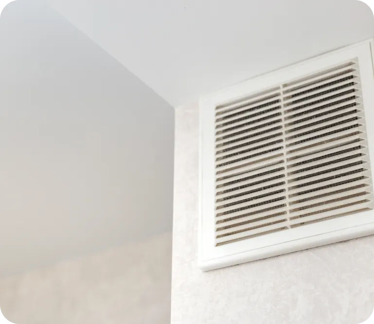 Air vent on a wall, illustrating air quality enhancements and ventilation solutions for improved indoor air circulation.