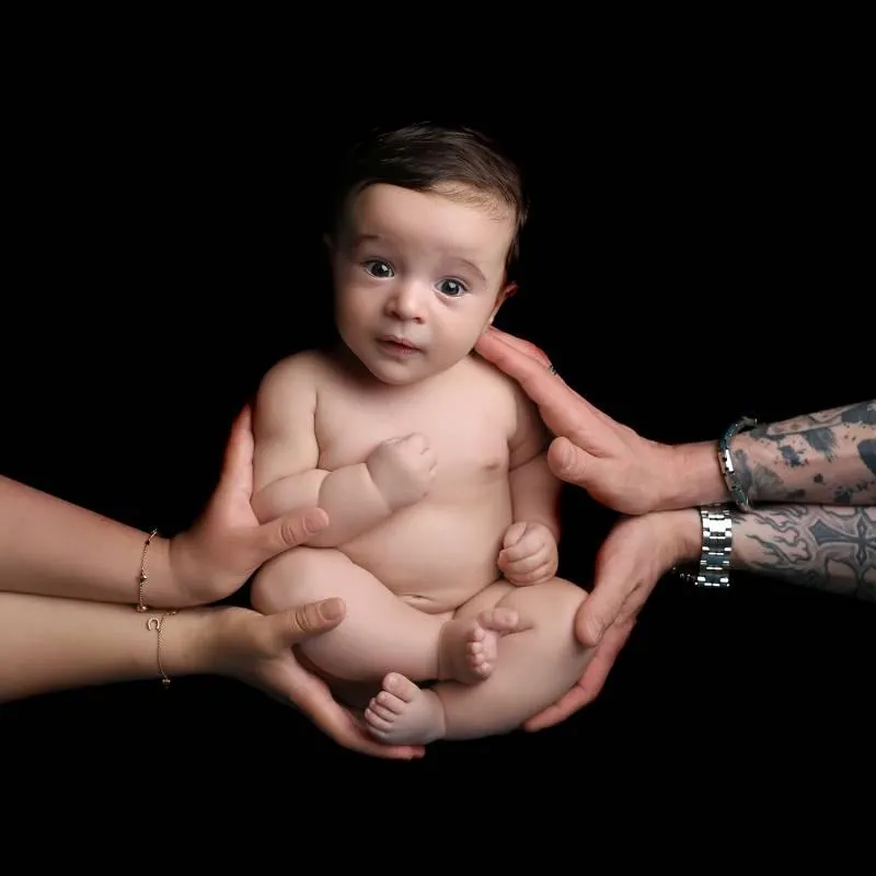 Photo of baby being held by its parents for Baby Art Studios Gallery