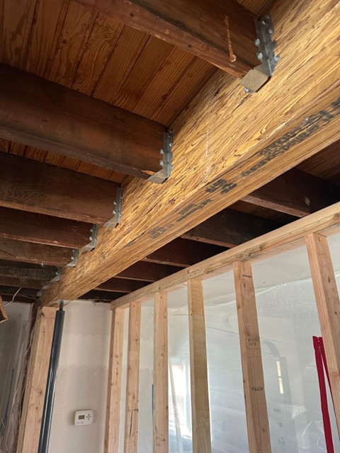 High-contrast exposed structural framing and load-bearing beam analysis