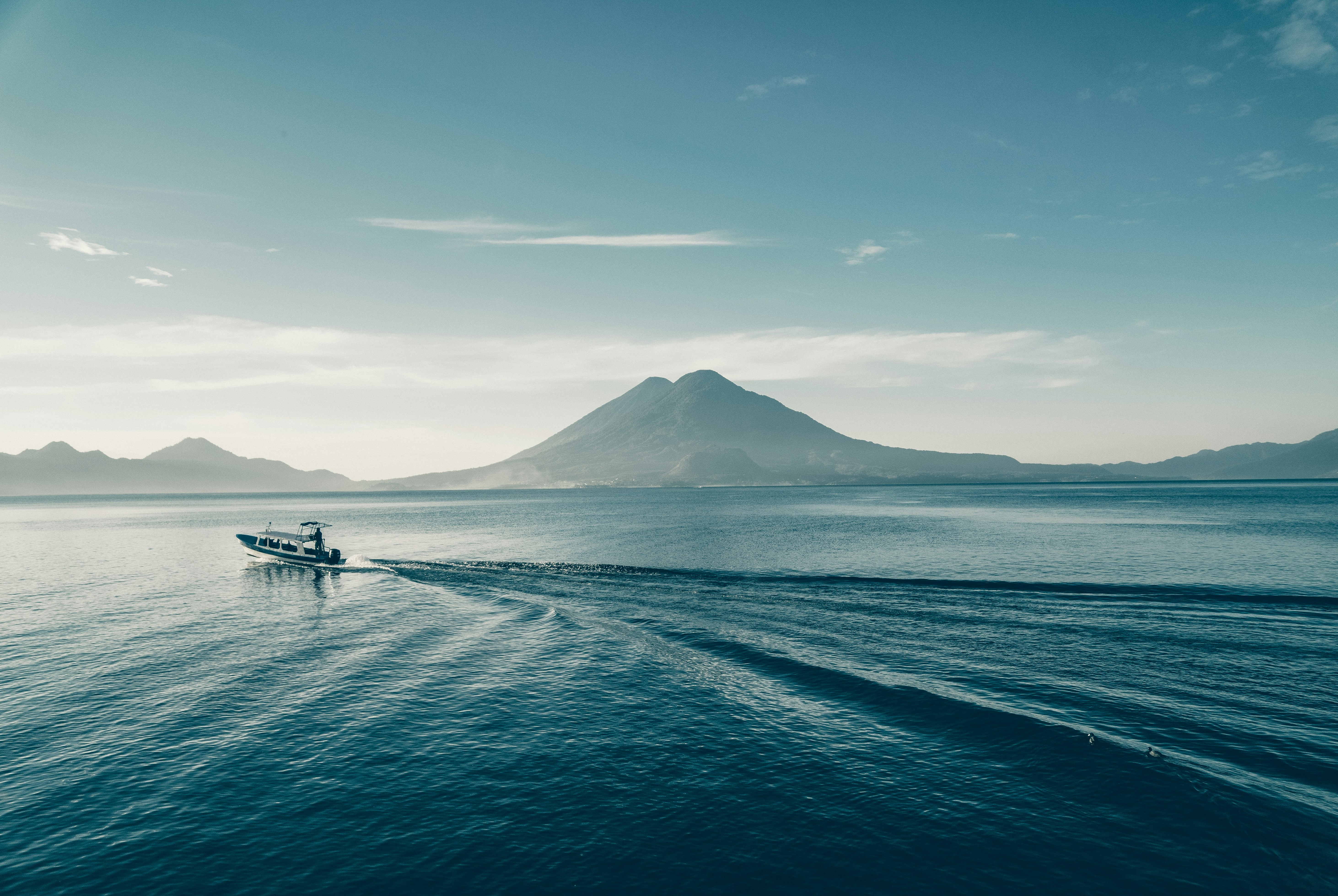 Two women practicing yoga outdoors in autumn park.