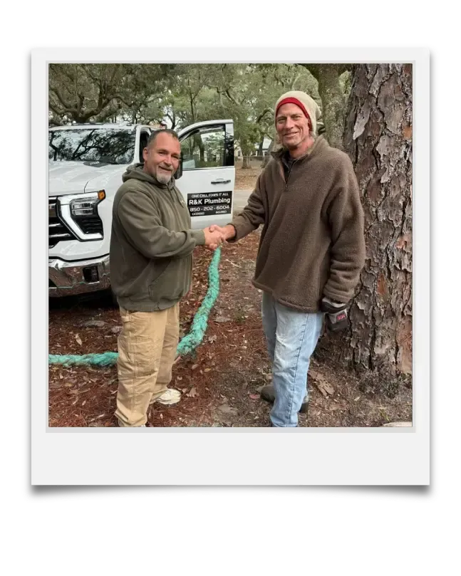 Rob from R&K Plumbing shaking hands after septic system replacement in Pensacola, FL