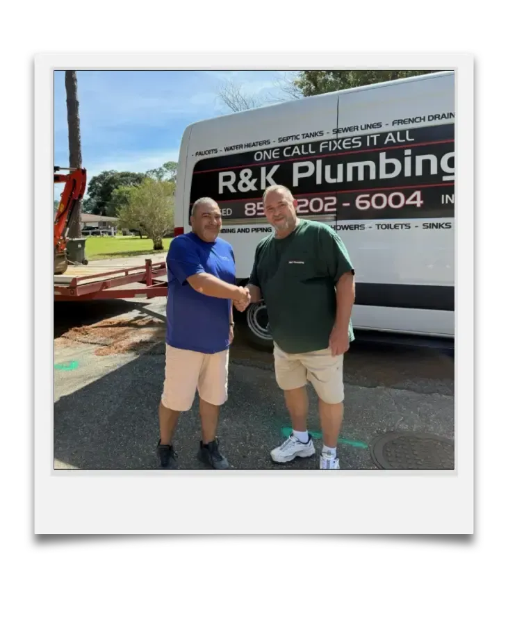 Rob from R&K Plumbing shaking hands after septic system replacement in Pensacola, FL