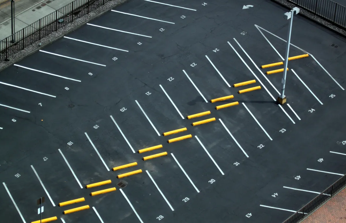 Seal-coated asphalt parking lot showing smooth black finish and professional pavement protection