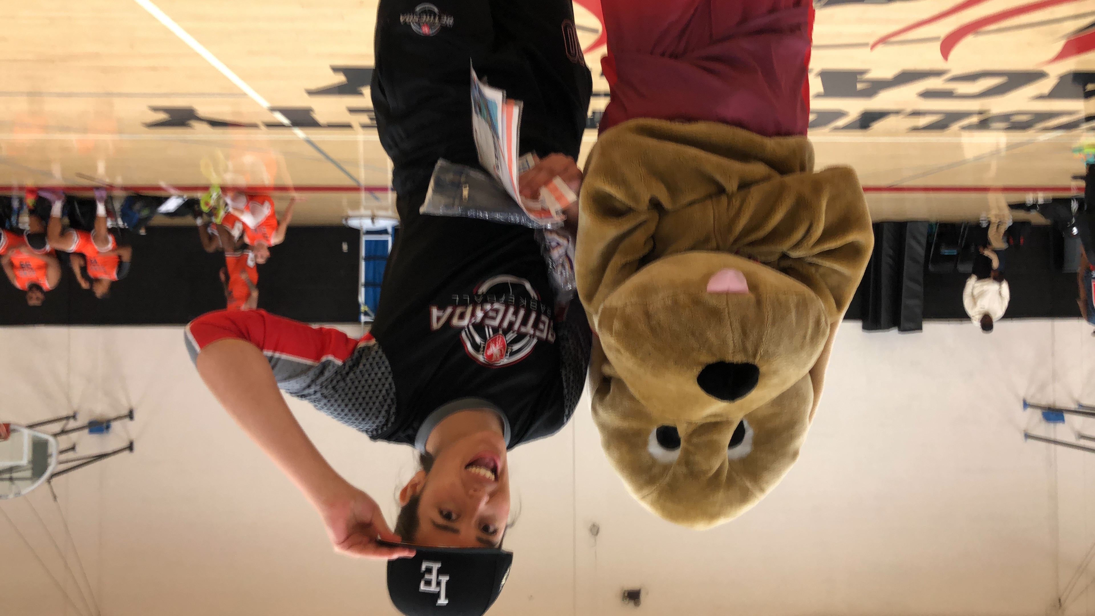 orange canoe on lake surrounding with mountain at daytime