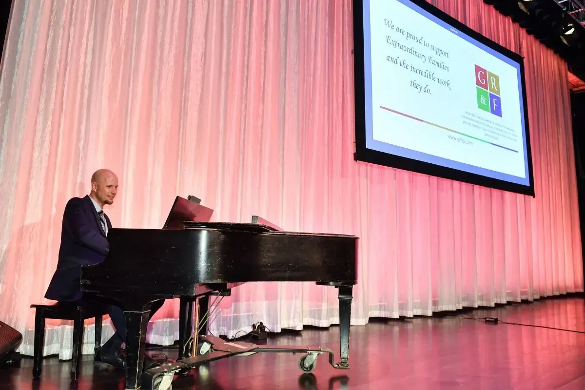 Jeremy Weinglass performing on stage at Extraordinary Families Gala at the Four Seasons Beverly Wilshire Hotel