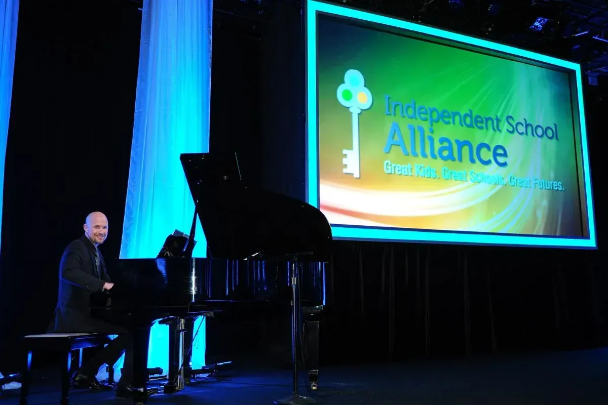 Jeremy Weinglass performing on stage at Independent School Alliance Gala at the Four Seasons Beverly Wilshire Hotel