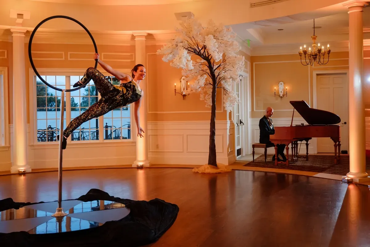 Jeremy Weinglass performing with aerialist on lollipop at River House Saint Augustine