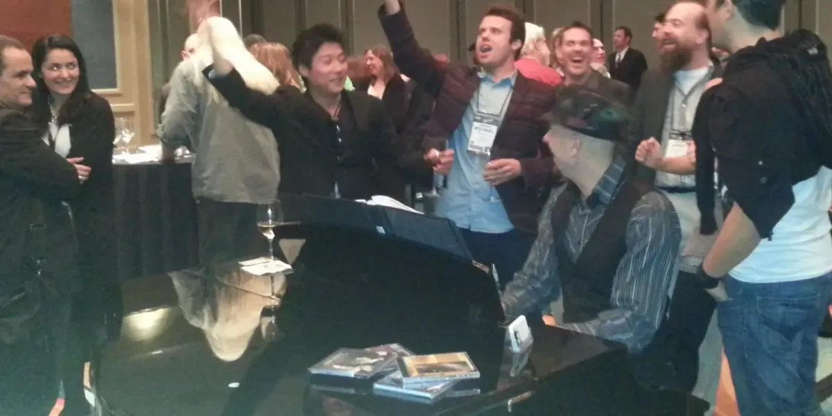 Pianist Jeremy Weinglass accompanying sing along a NAMM VIP reception
