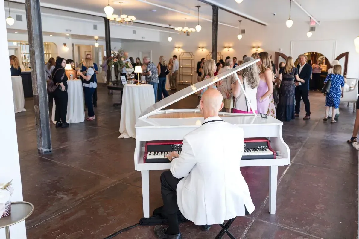 Jeremy Weinglass playing white baby grand piano shell for cocktail hour at The Venu in Hastings