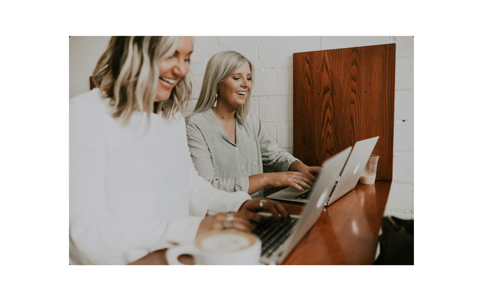 Two females working on laptops