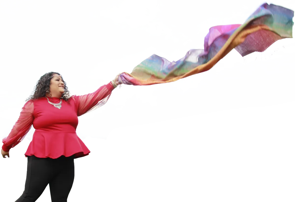 Image of Jikara waving a colorful scarf in the air.
