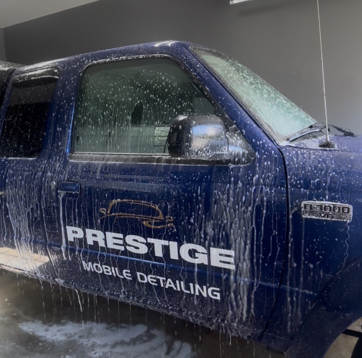 Man cleaning car dashboard with brush