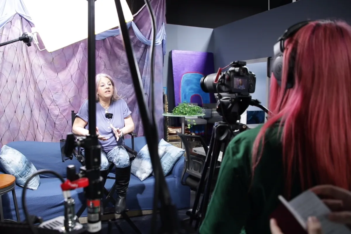 Students working together during a documentary filmmaking session using professional cameras and audio equipment in a hands-on media production environment.
