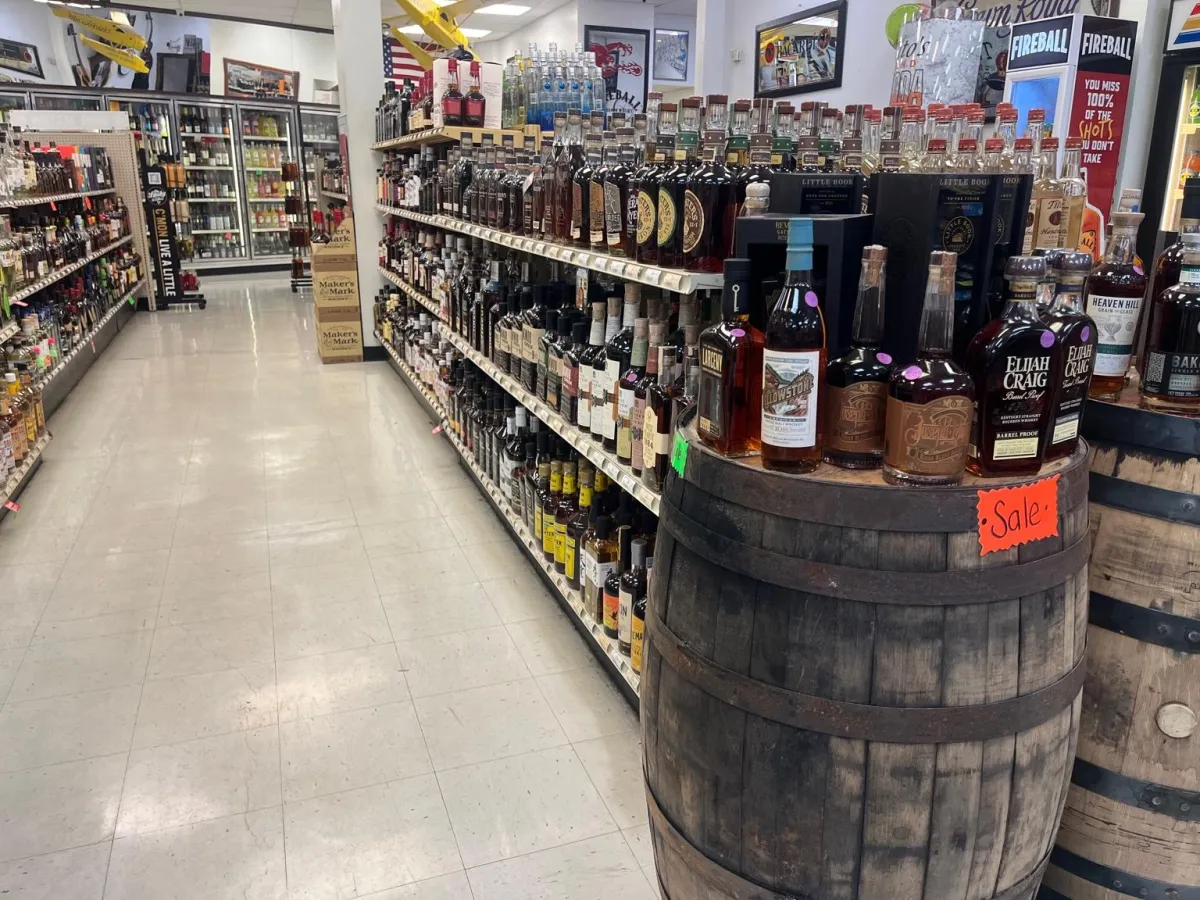 Close detail of a tasting counter with glasses and a highlighted bottle.