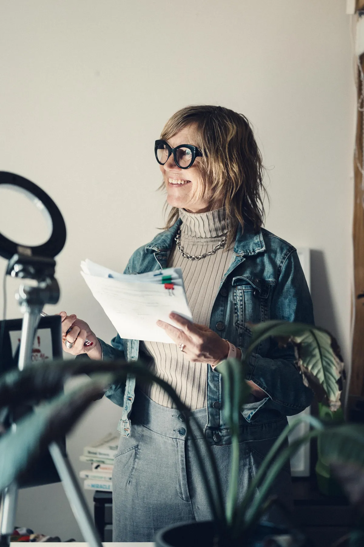 Gry holding a script and looking to her right