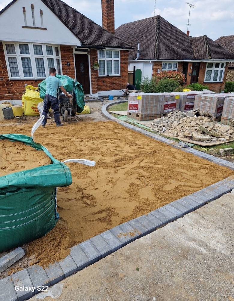 Driveway sub-base preparation with edge restraints set on concrete haunch
