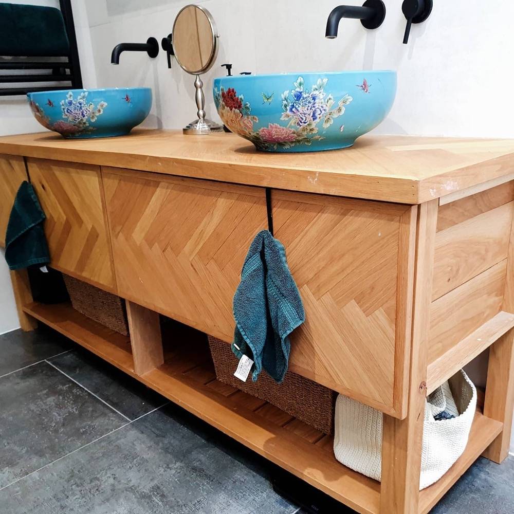 Bespoke wooden double vanity with hand-painted basins in refurbished bathroom
