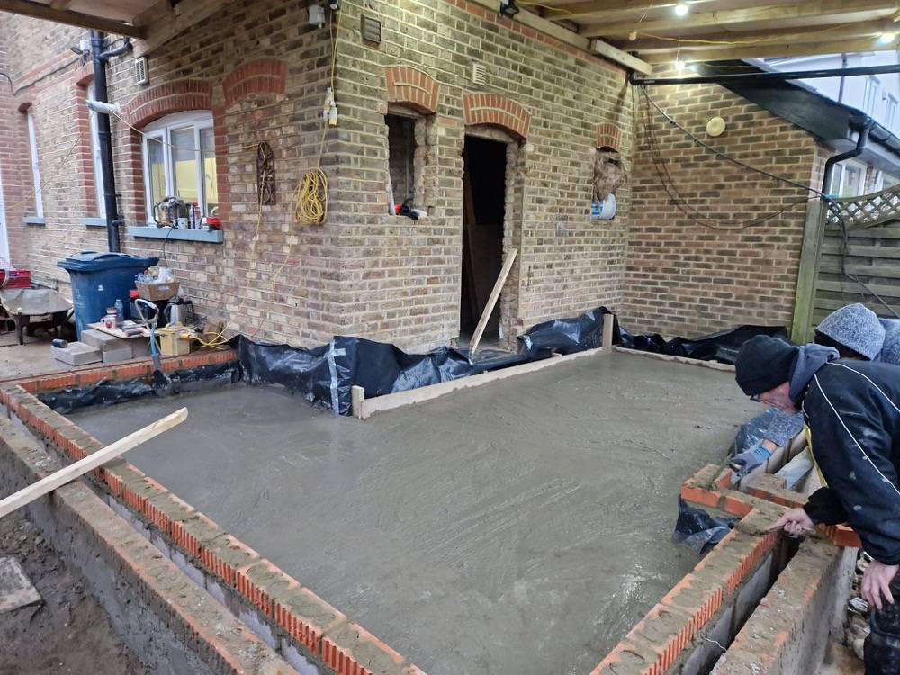Concrete slab and brick walls during extension groundworks by DR Construction
