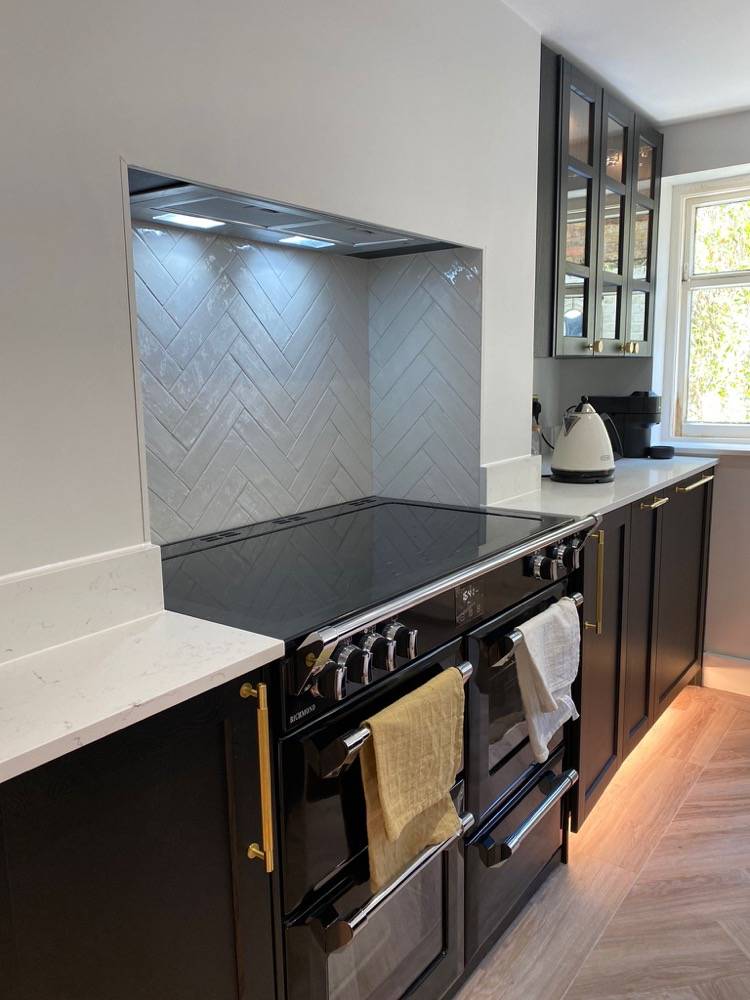 Kitchen with black range cooker and herringbone tile splashback in Hemel Hempstead