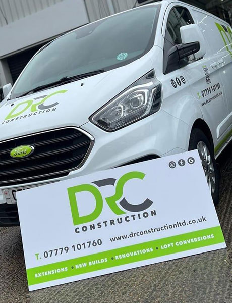 DR Construction van with oversized business card in front, displaying contact information