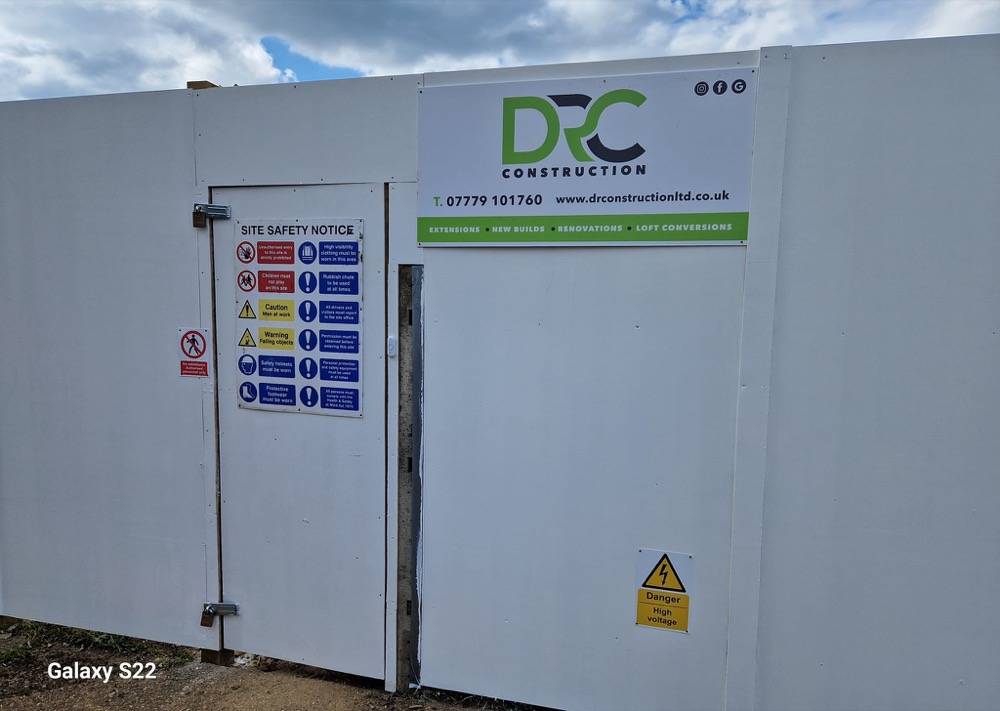 DR Construction site hoarding showing company branding and contact details