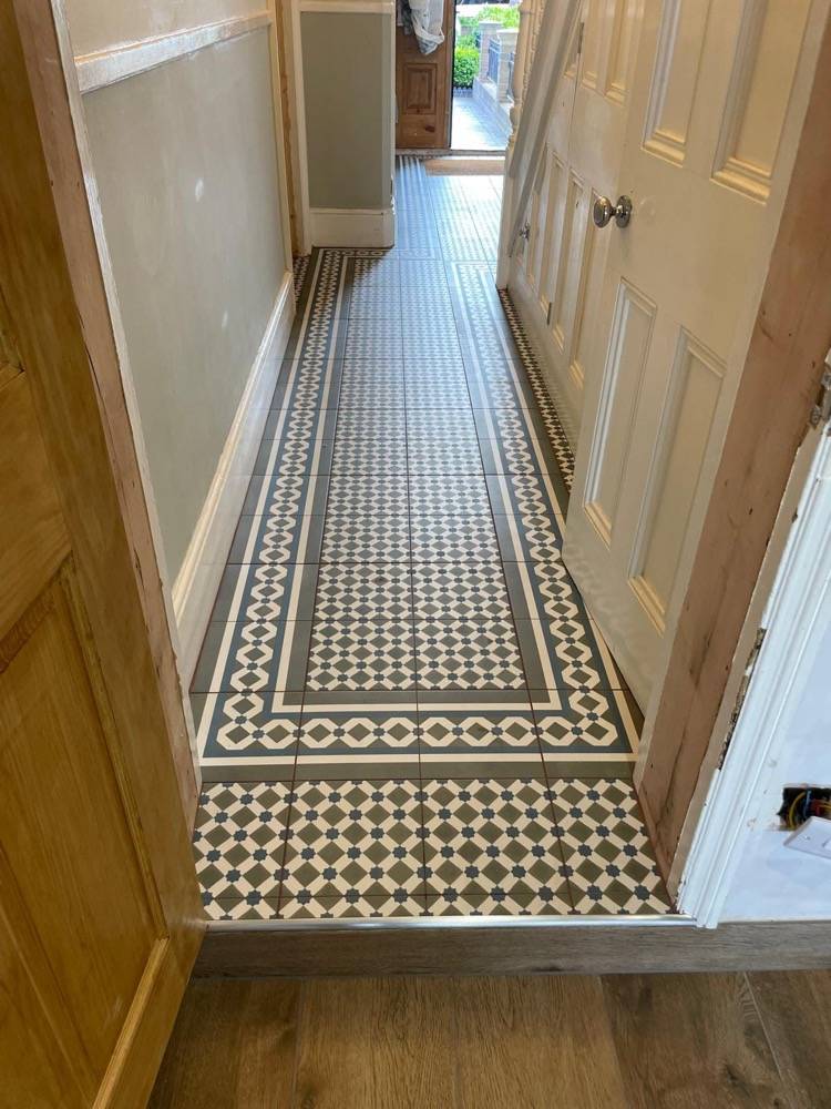 Patterned Victorian-style tiled hallway in refurbished period property by DR Construction