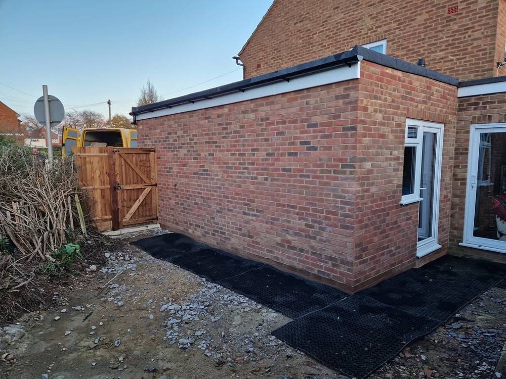 Finished single-storey rear extension with brick walls by DR Construction