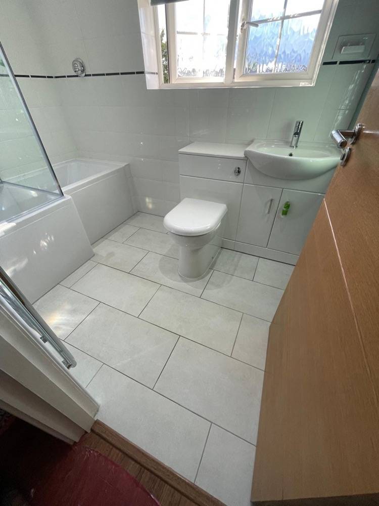 White bathroom with WC and vanity sink completed by DR Construction