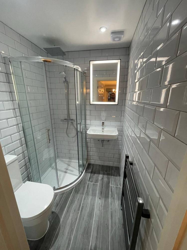 Grey metro tile bathroom with walk-in shower, WC and vanity by DR Construction