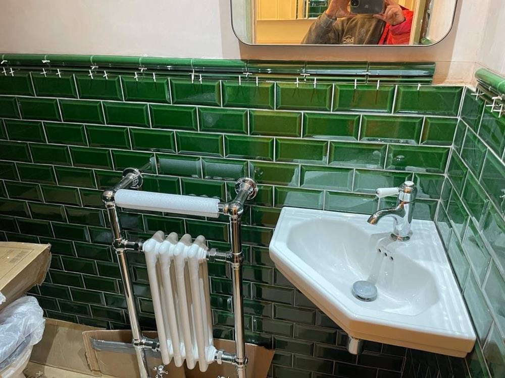 Green metro tile bathroom with pedestal basin and column radiator by DR Construction