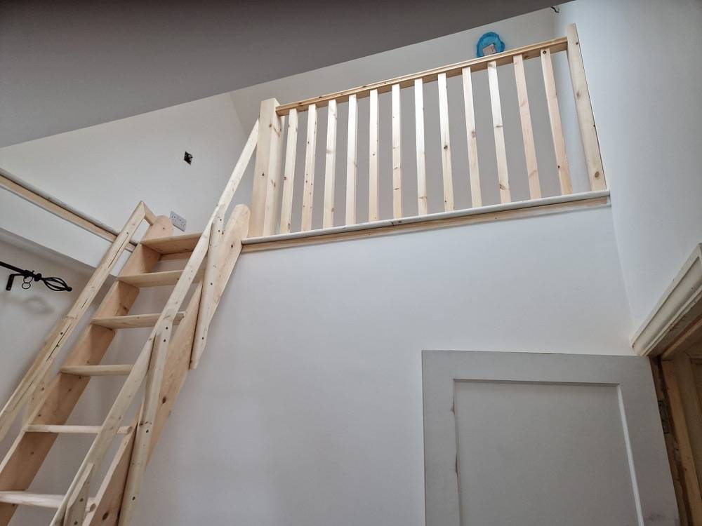 New wooden staircase leading up to loft conversion landing